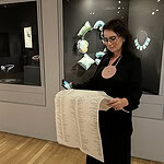 The gallerist Sofia Björkman peruses the exhibition guide for Constellations, photo: Elena Karpilova