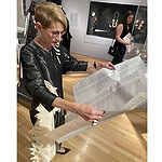 AJF member Bonnie Levine reading the atlas that is the exhibition guide for Constellations: Contemporary Jewelry at the Dallas Museum of Art! Photo: Stefanie Fedor