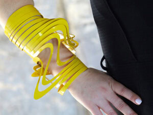 Ellina Pollitt, Solar Flow Cuff—Yellow Cuff, 2024, bracelet, aluminum, powder coating, approx. 20 × 10 × 10 cm, one of a kind, photo courtesy of The Image Factory