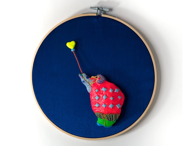 Coco Sung, Shadow Kkokdu, 2025, brooch (mounted on silk in embroidery hoop) in clay, lacquer, beads, Swarovski stones, wire, spring, brooch 3 ½ x 2 ⅜ x ⅝ inches (90 x 60 x 15 mm), photo courtesy of the artist and Galerie Door