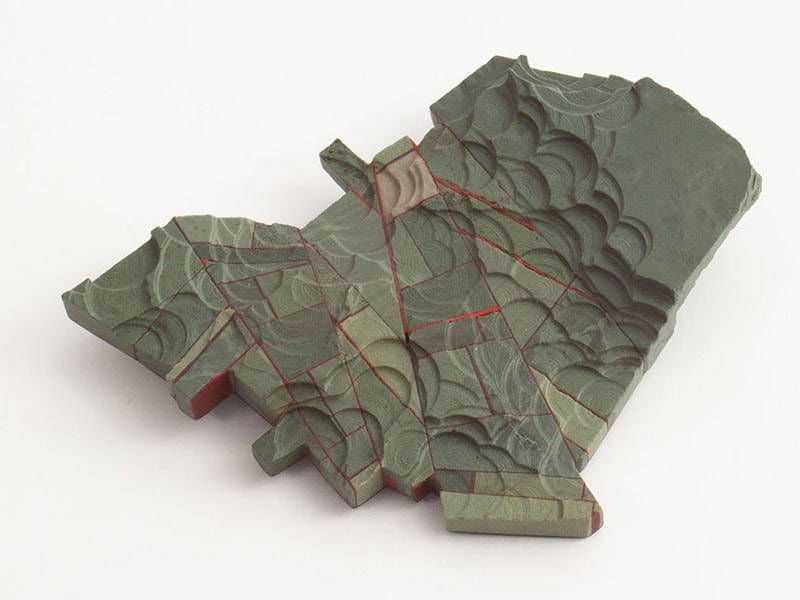 Craig McIntosh, Topography Brooch, 2025, in Pakohe/metamorphic argilite, fiber carbon, silver, structural adhesive, 3 ¾ x 4 ⅞ x ⅝ inches (95 x 123 x 17 mm), photo: artist