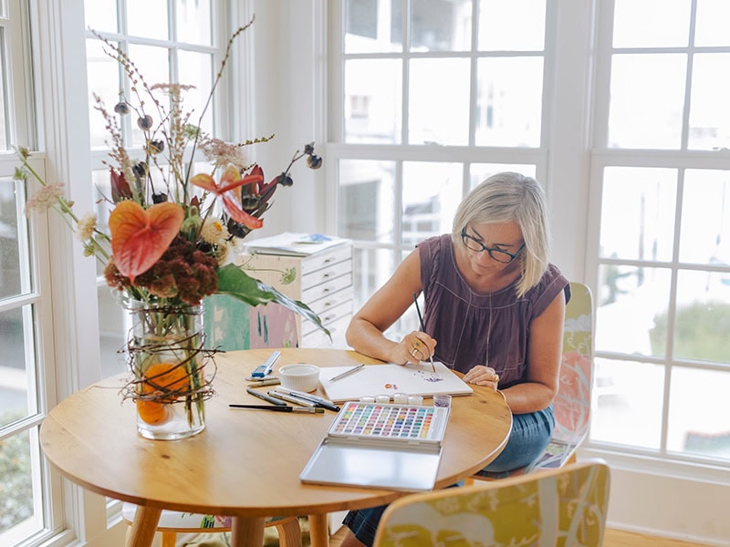 One of Heidi's favorite things to do at the gallery is her Heirloom Reimagined work. Every month, Heidi sits down with clients to help them redesign their heirlooms to make something new they love. This image shows her designing and arranging stones, photo: Maria DeForrest