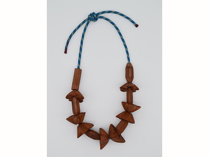 Caio Mahin, Dorothea Prühl in Hawaii, 2026, necklace in paracord, walnut wood, 12 ⅝ x 8 ½ x ¾ inches (320 x 215 x 20 mm), photo: Pierre Primetemps