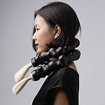In this photo, the model wears two of the same choker. | Ryan Seng, Encased Bubble Choker, 2026, in silver, goat hair, rubber, 9 x 15 inches (22.8 x 38.1 cm), photo: Eric Perry