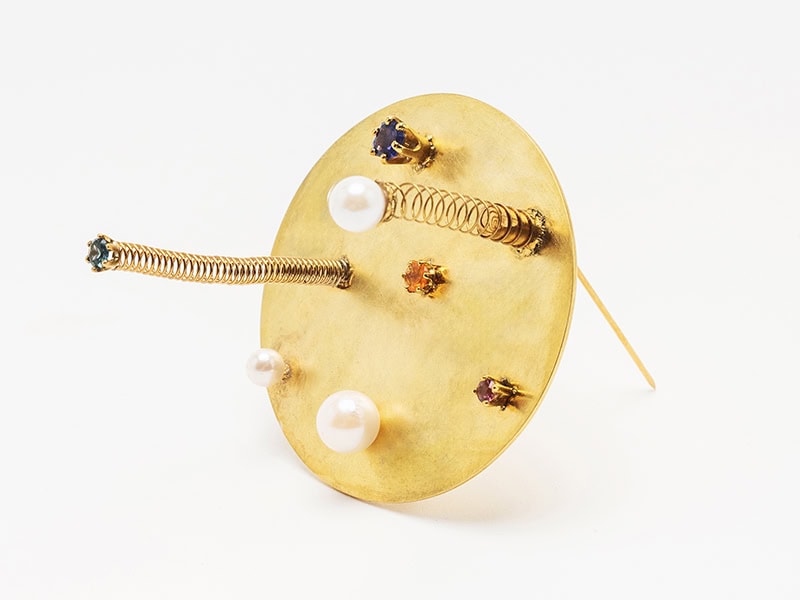 Réka Lőrincz, Strike the Pose, 2022, brooch in gold-plated silver, sapphire (purple from Sri Lanka, green from Montana), pink spinel, fire opal, Akoya pearl, stainless steel, 2 x 2 x 1 ⅛ inches (50 x 50 x 30 mm), photo: Sofia Björkman
