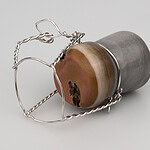 Kupri’s thesis work was praised for its courage in addressing a subject that, without embarrassment or pretense, captures spirited moments of celebration through jewelry and objects crafted from precious metals and gemstones. | Alice Kupri, Left to Be Forgotten, 2026, a life-sized champagne cork carved from jasper, finished with silver wire detailing, photo: artist