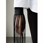 Finishing the edges of the leather in Weerhaken I with long strips of thread gives the work an elegant yet playful appearance, making it visually compelling in both photography and runway contexts. The barbs symbolize Vervoort’s critical thoughts. They represent her attempt not to let these thoughts dictate her actions anymore, but instead to transform them into a force that creates space for growth and experimentation as a jewelry designer. | Rune Vervoort, Weerhaken I, 2026, in leather, polyester yarn, metal hooks, photo: Lela Van Dam