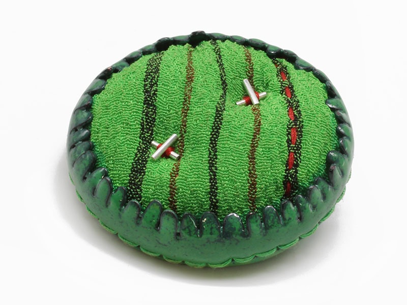 Jina Seo, Mow the Lawn: Green Pebble, 2026, brooch in enamel on copper, shower cloth, sterling silver, thread, 2 x 2 x ½ inches (51 x 51 x 13 mm), photo: artist