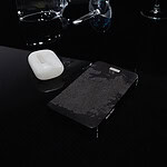 Working primarily with silver, glass, and various minerals, Kupri aims to capture moments and objects that often go unnoticed or are considered insignificant. | Alice Kupri, Left to Be Forgotten, 2026, life-sized phone carved from jet, AirPods case carved from alabaster, both finished with silver details, photo: artist