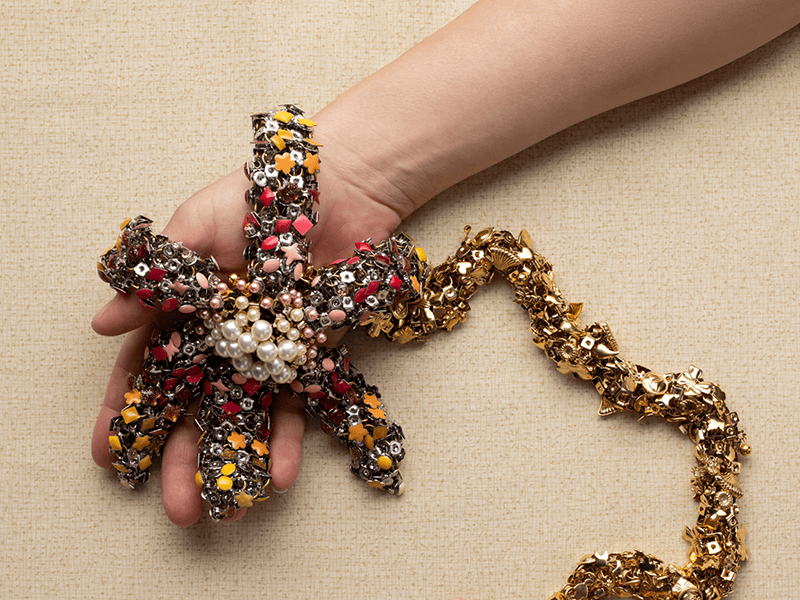 Emily Cobb, Floppy Flower, 2026, in gold-plated brass ear nuts, surgical steel ear nuts, assorted deadstock stud earrings, brass jump rings, silver-filled jump ring, 30 x 8 x 1 ½ inches, photo: Madison Hoffman and Auriele Gould