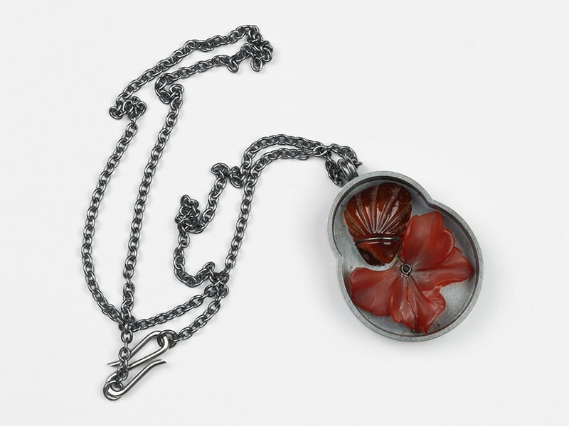 Catarina Silva, Untitled, 2026, pendant in oxidized silver, coralline, agate, 50 x 35 x 8 mm, chain 250 mm long, photo: Pedro Tropa Video? No